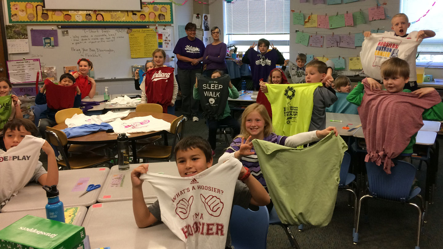 Children holding reusable bags made from old T-shirts