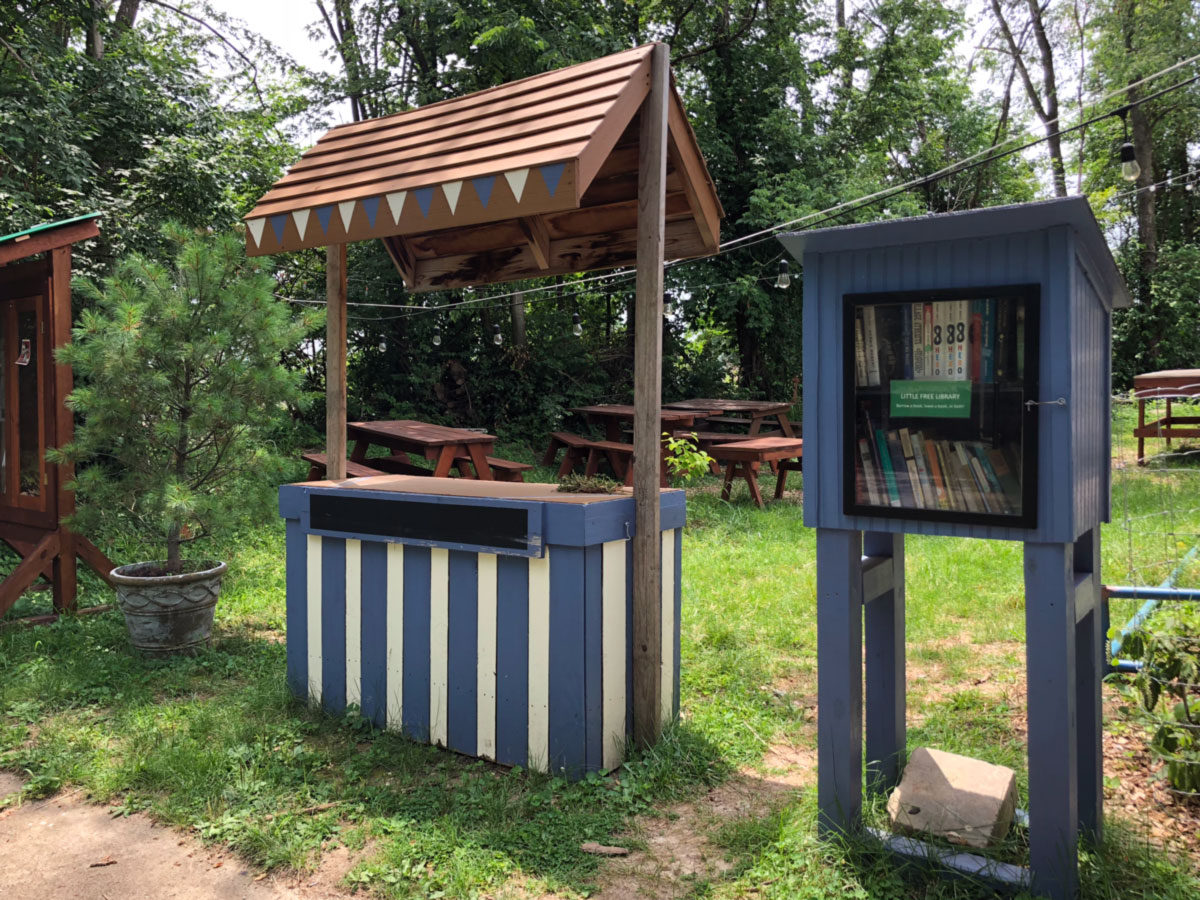 Little Free Library and a stand outside The Overlook
